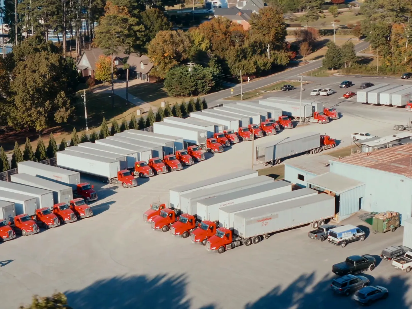 Red TM Freight trucks parked in rows at the mill’s truck yard